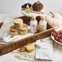 Load image into Gallery viewer, Navy brand products including bottles, jars, and boxes on a decorative tray with pumpkins and grapes.