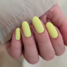 Charger l'image dans la galerie, Hand with bright yellow nail polish on a neutral background