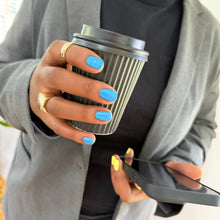 Charger l'image dans la galerie, Person holding a coffee cup and phone with blue nail polish