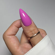 Charger l'image dans la galerie, Hand with purple nail polish and a gold ring on a neutral background