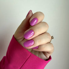 Charger l'image dans la galerie, Hand with pink nail polish wearing a bright pink sleeve against a plain background