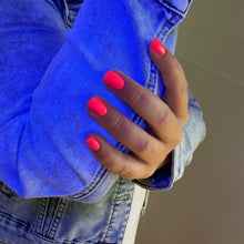 Charger l'image dans la galerie, Close-up of a person wearing a blue denim jacket with pink nail polish on their fingers.