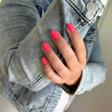 Charger l'image dans la galerie, Person wearing a denim jacket with pink nail polish on their hand.