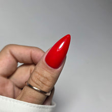 Charger l'image dans la galerie, Hand with red nail polish on a plain background