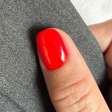 Charger l'image dans la galerie, Close-up of a red nail on a finger with a gray fabric background