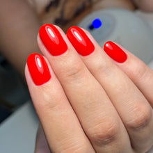 Charger l'image dans la galerie, Close-up of a hand with red nail polish on a blurred background