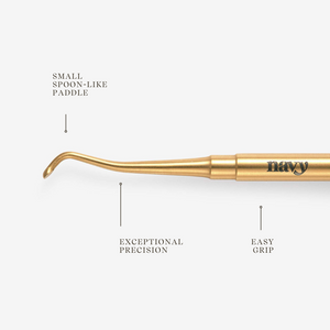 Gold manicure tool with features labeled on a white background