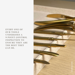 Gold tools arranged on a wooden surface with text about quality control.