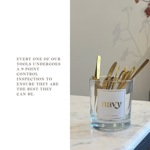 Glass container with gold tools on a marble surface, text about tool inspection.