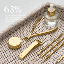 Load image into Gallery viewer, Set of gold beauty tools on a woven tray with a bottle labeled &#39;navy&#39;.