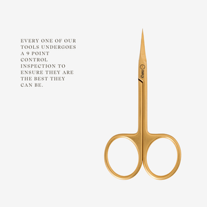 Gold cuticle scissors with brand logo on a white background