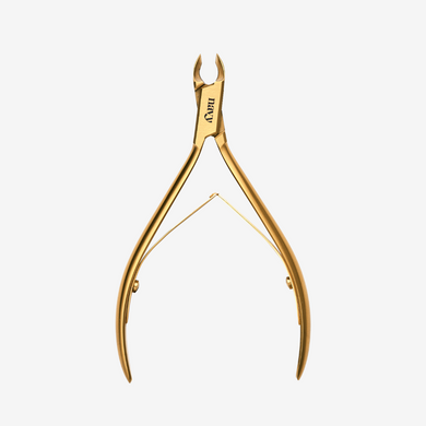 Gold nail clipper on a white background