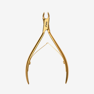 Gold nail clipper on a white background