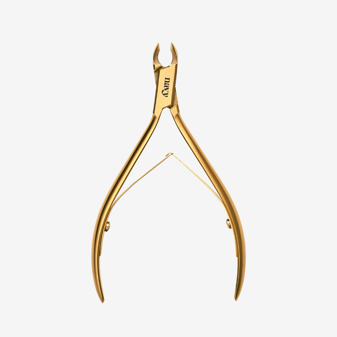Gold nail clipper on a white background