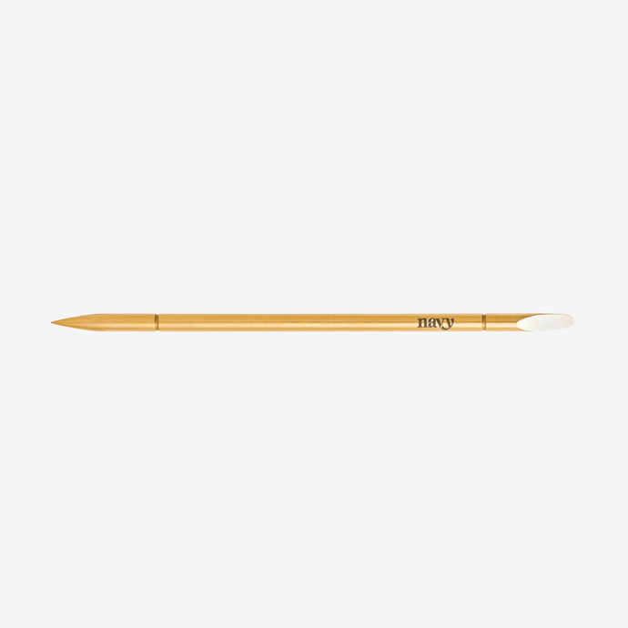 Navy makeup brush on a white background