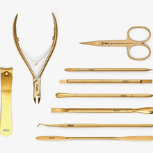 Load image into Gallery viewer, A set of nail tools laid out on a white background, including various cuticle scissors, a file, and other manicure tools with a gold-colored finish.