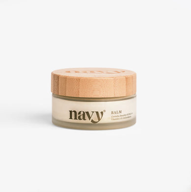 Jar of balm with a wooden lid on a white background, branded 'navy'.