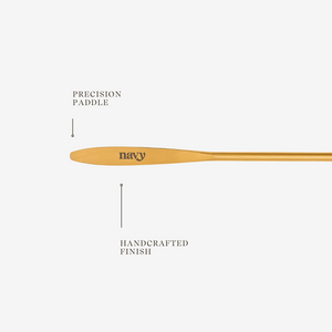 Gold  paddle with 'navy' branding on a white background